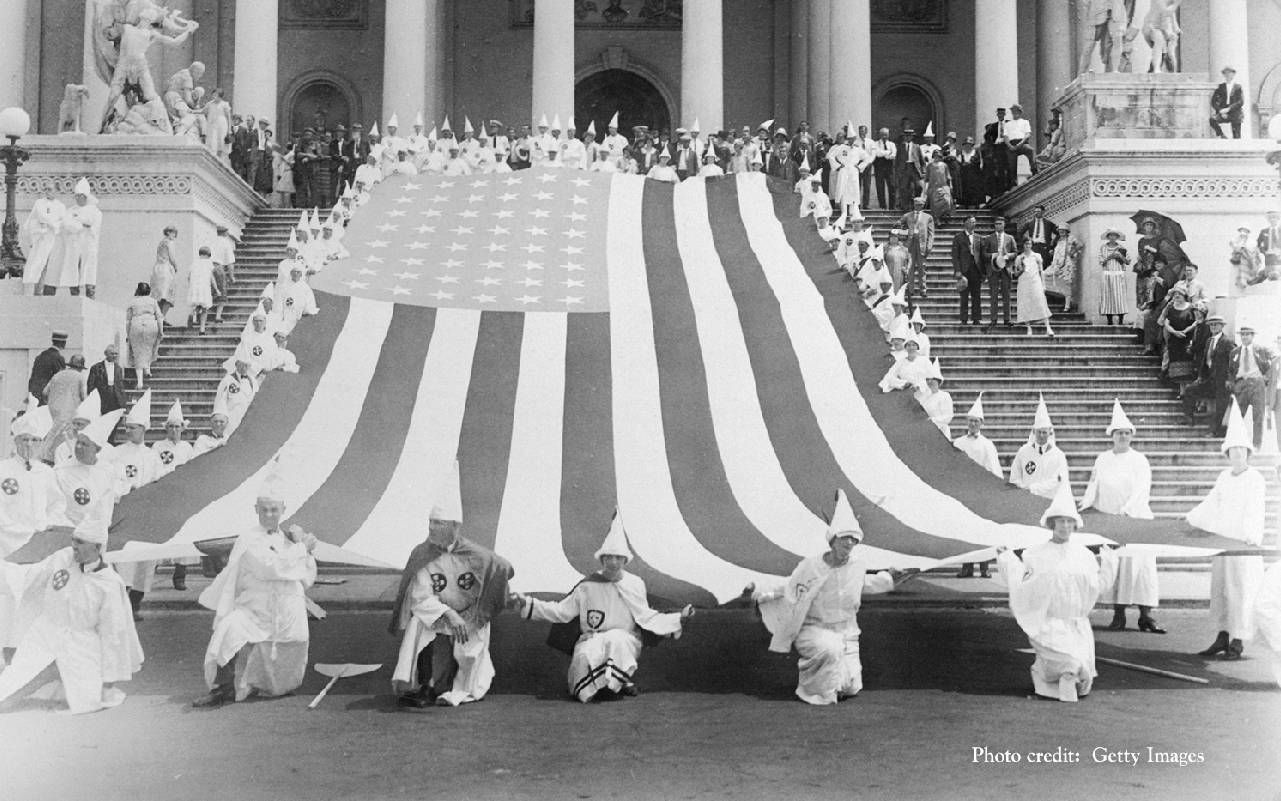 KKK members holding an American flag. Next Avenue, Ken Burns, Our America