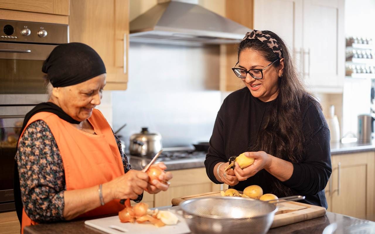 A caregiver with her mom making dinner. Next Avenue, family caregivers, caregiving