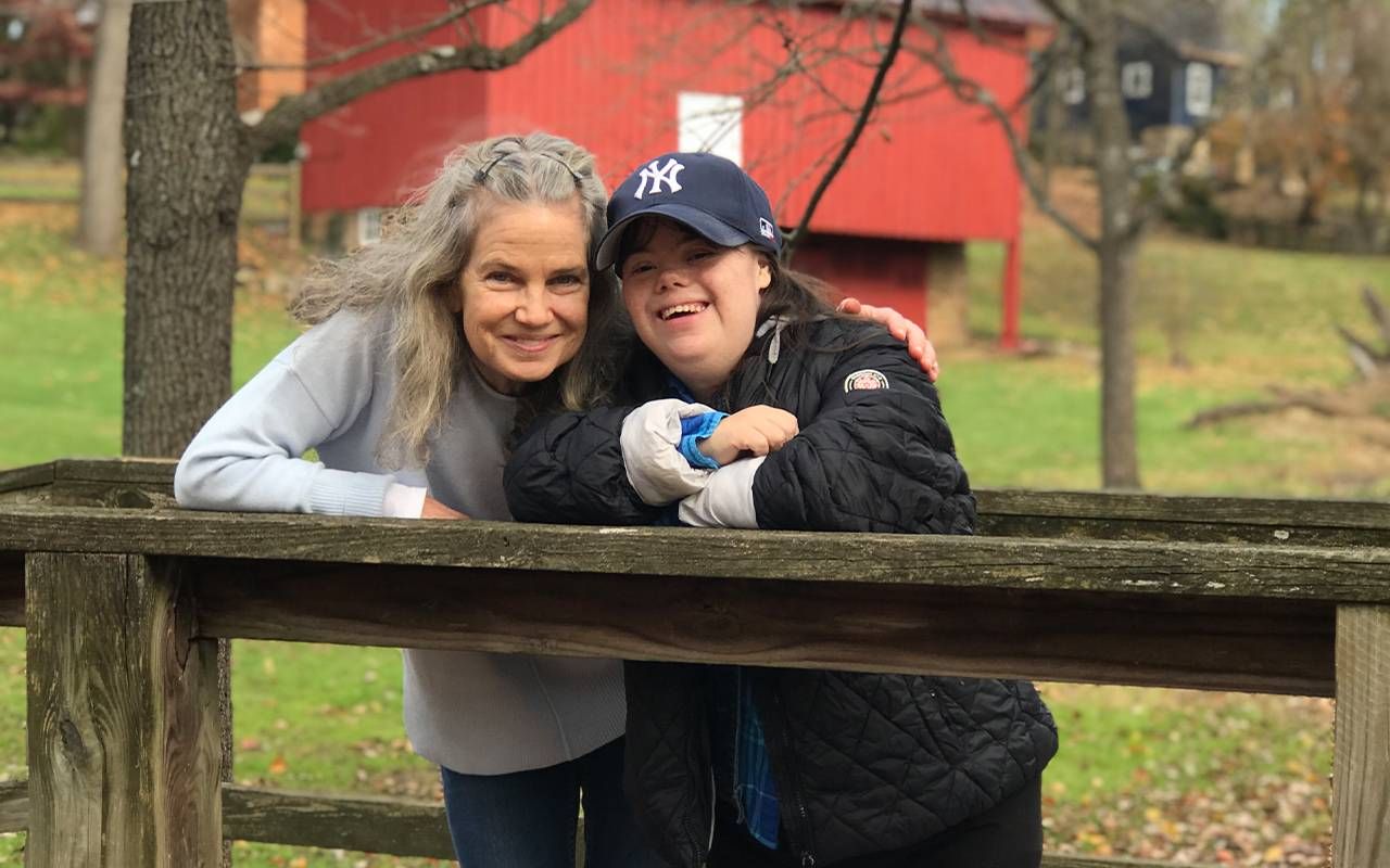 A mother and daughter hugging and smiling outside. Next Avenue, developmental disabilities, end of life care