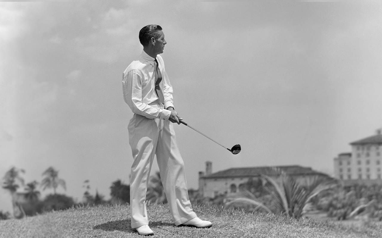A black and white photo of a man playing golf. Next Avenue, golf, golfing
