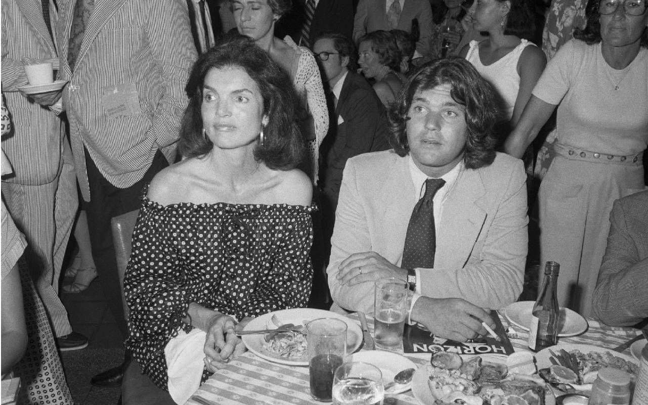 A man sitting at a table with Jackie O. Next Avenue, Jan Wenner, Rolling Stone, book