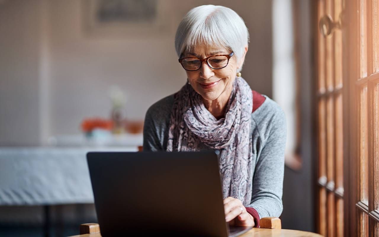 A woman signing up for medicare during open enrollment. Next Avenue