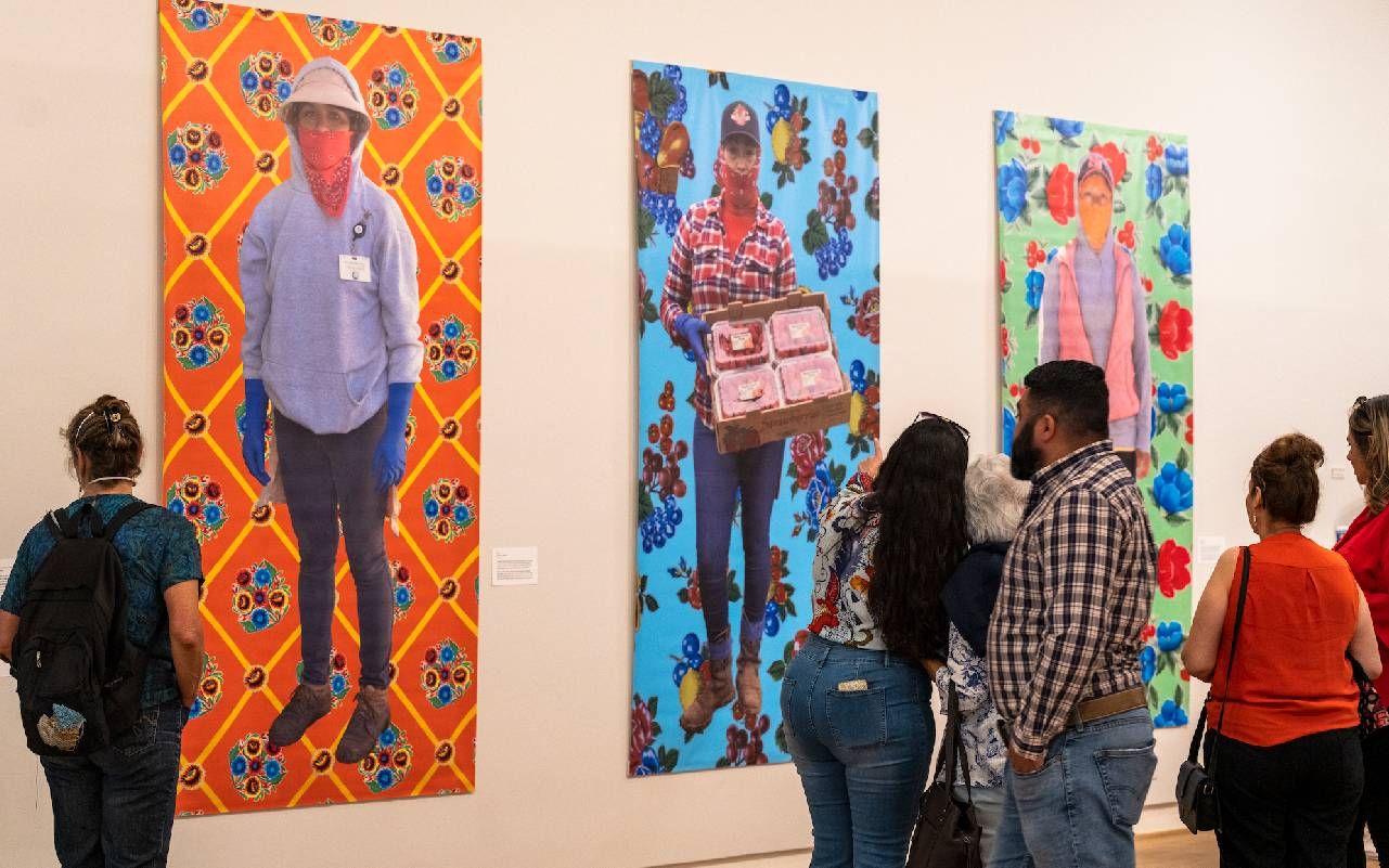 People looking at colorful paintings in a museum. Next Avenue, Santa Cruz Museum of Art and History