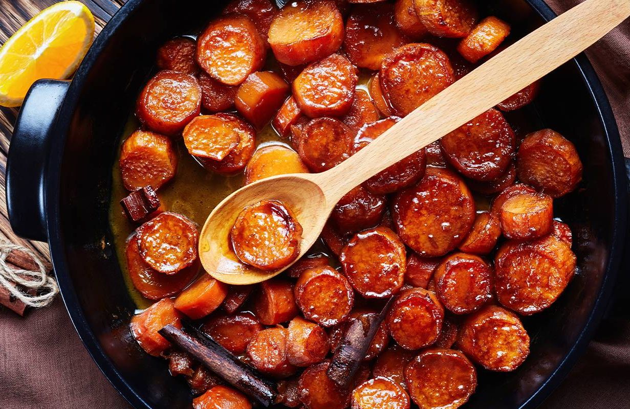 candied sweet potatoes cooking in a cast iron pan. Next Avenue, recipe