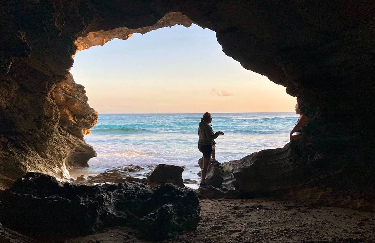 A widowed woman on a trip looking out to the ocean from a cave. Next Avenue, grief and travel