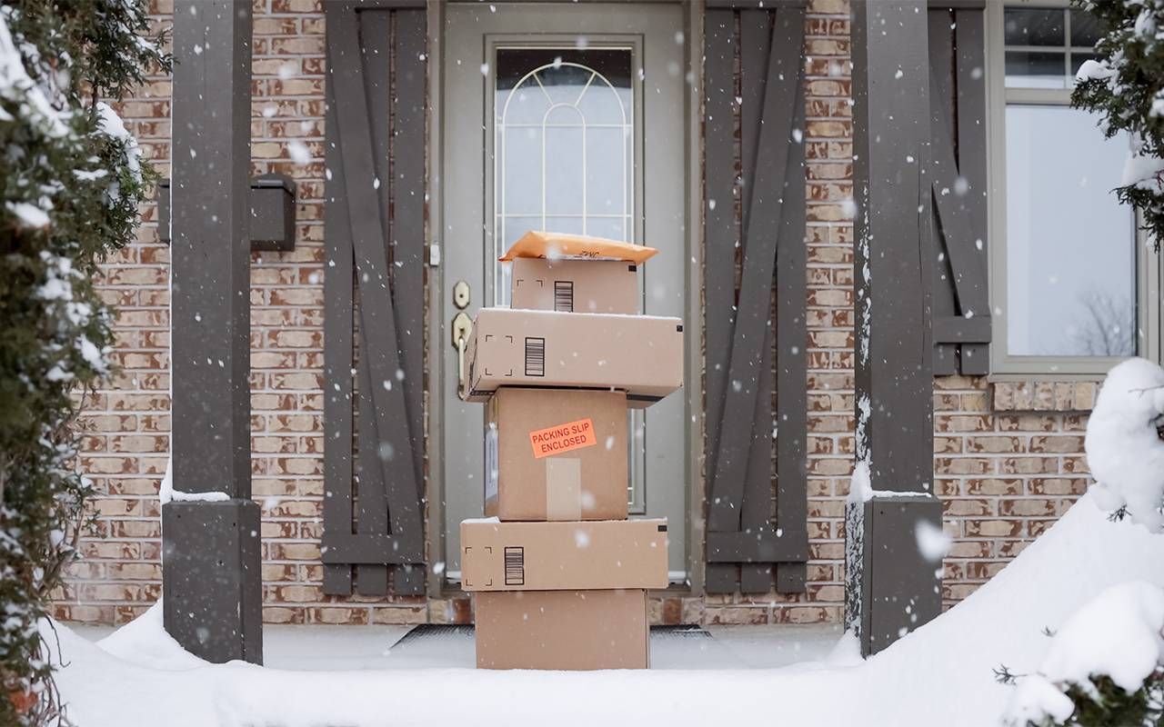 A pile of boxes from online shopping outside of a person's front door. Next Avenue, hoarding disorder, holiday shopping, triggers