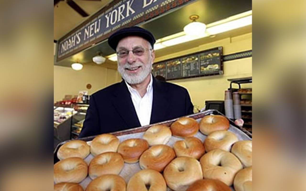 A man holding a tray of bagels. Next Avenue, starting a business