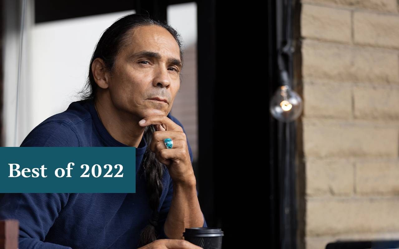 A man sitting and holding a cup of coffee. Next Avenue, Longmire, Reservation Dogs, Zahn McClarnon