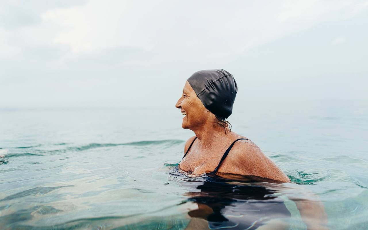 An older woman swimming in a lake. Next Avenue, body neutrality