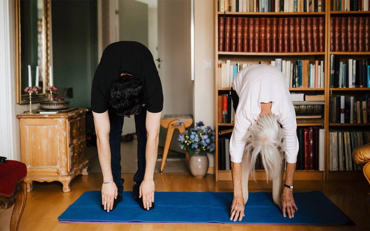 A homecare assistant exercising with an older adult. Next Avenue, home care apps