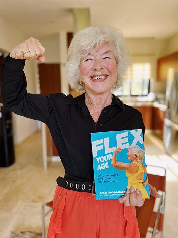 A woman flexing her arm muscles. Next Avenue, Flex your Age, Joan MacDonald