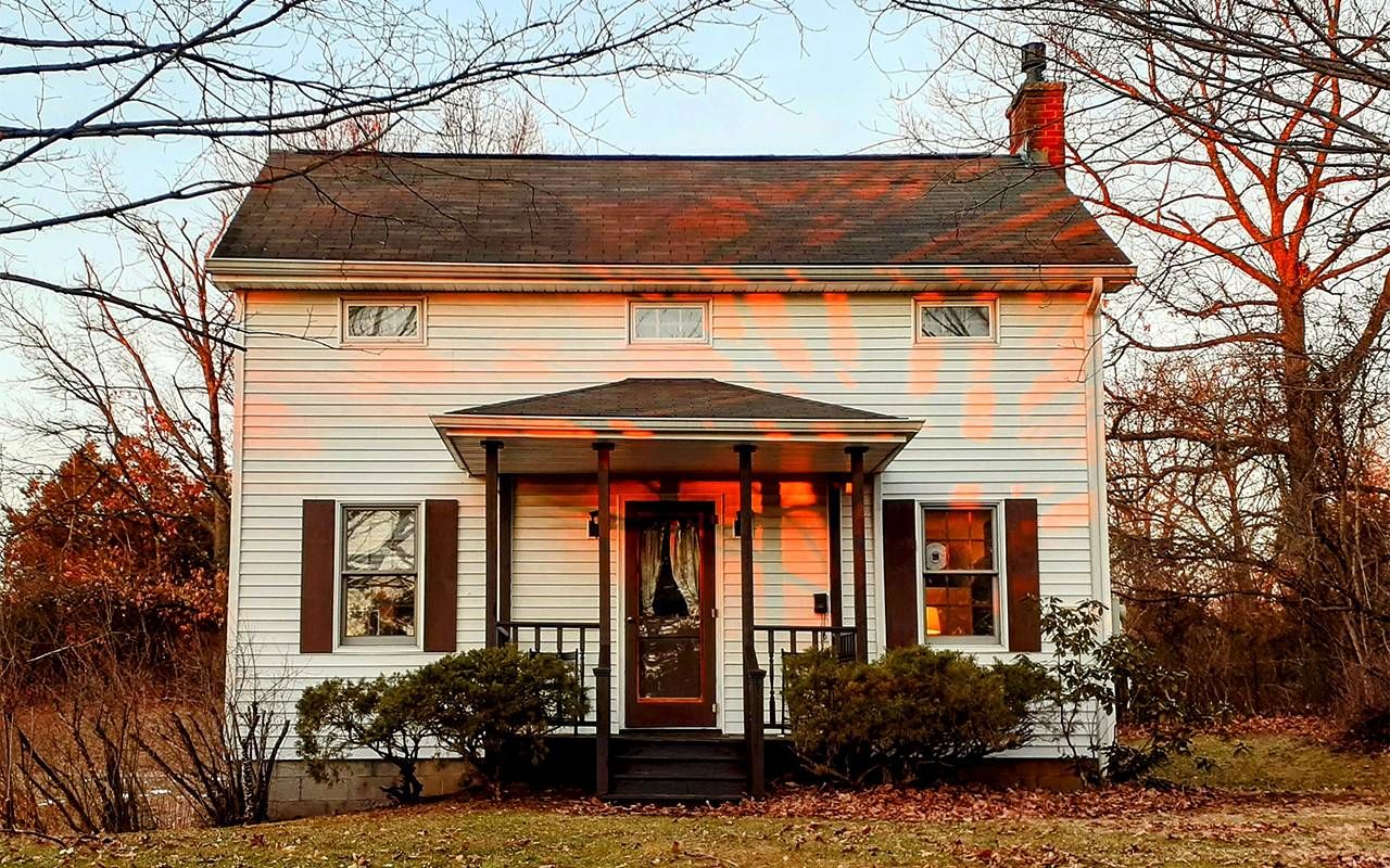 An old house glowing in the sunset. Next Avenue, old house