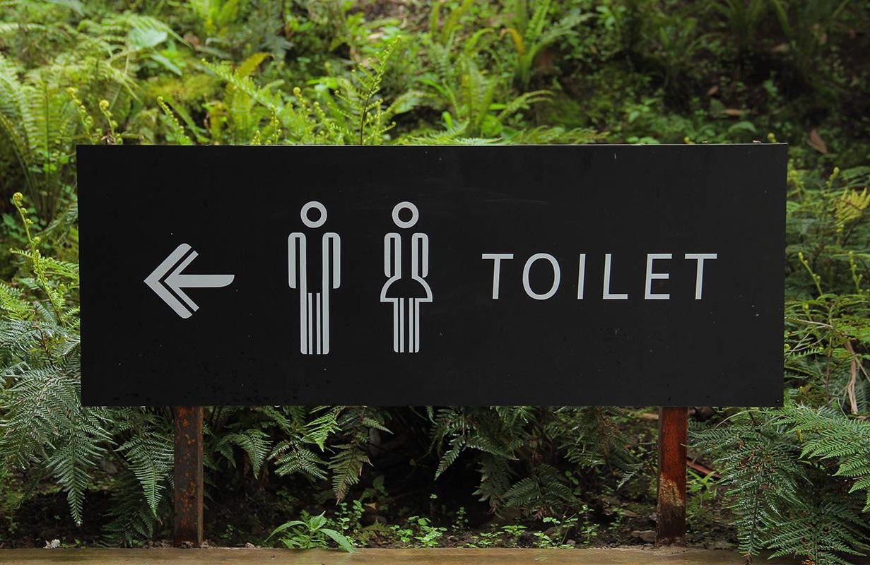 A sign for the bathroom sign along a hiking trail. Next Avenue, Urinary incontinence