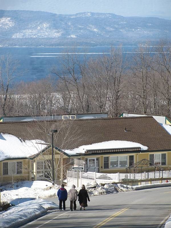 Three people walking down a road. Next Avenue, walkable retirement community