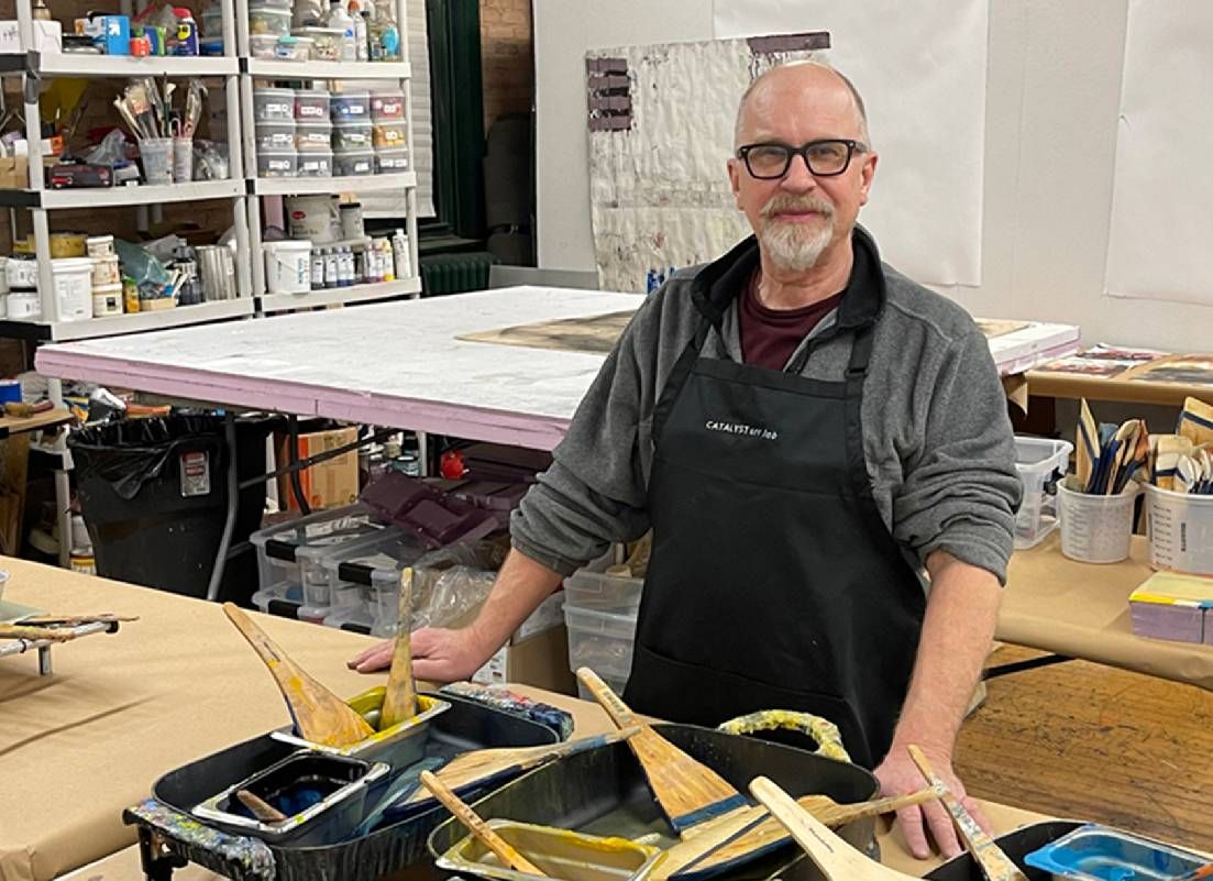 A man standing at a workbench. Next Avenue, arts communities