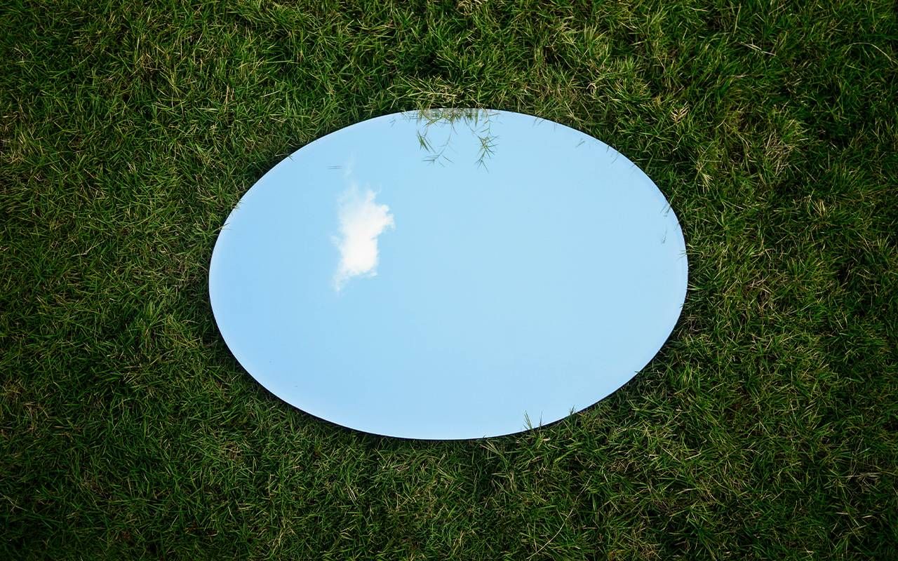 A mirror in a field of grass. Next Avenue, cataract surgery