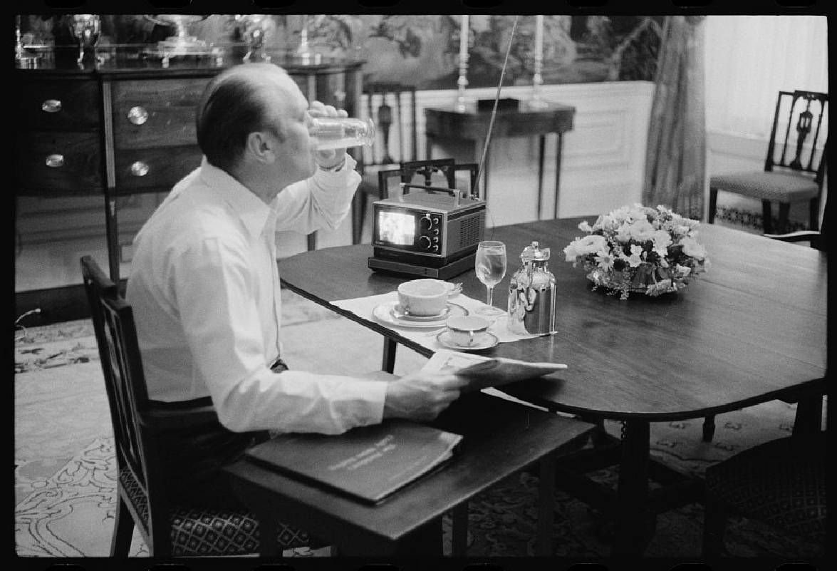 A man drinking from a glass at a table. Next Avenue, Dinner with the President, Alex Prud'homme