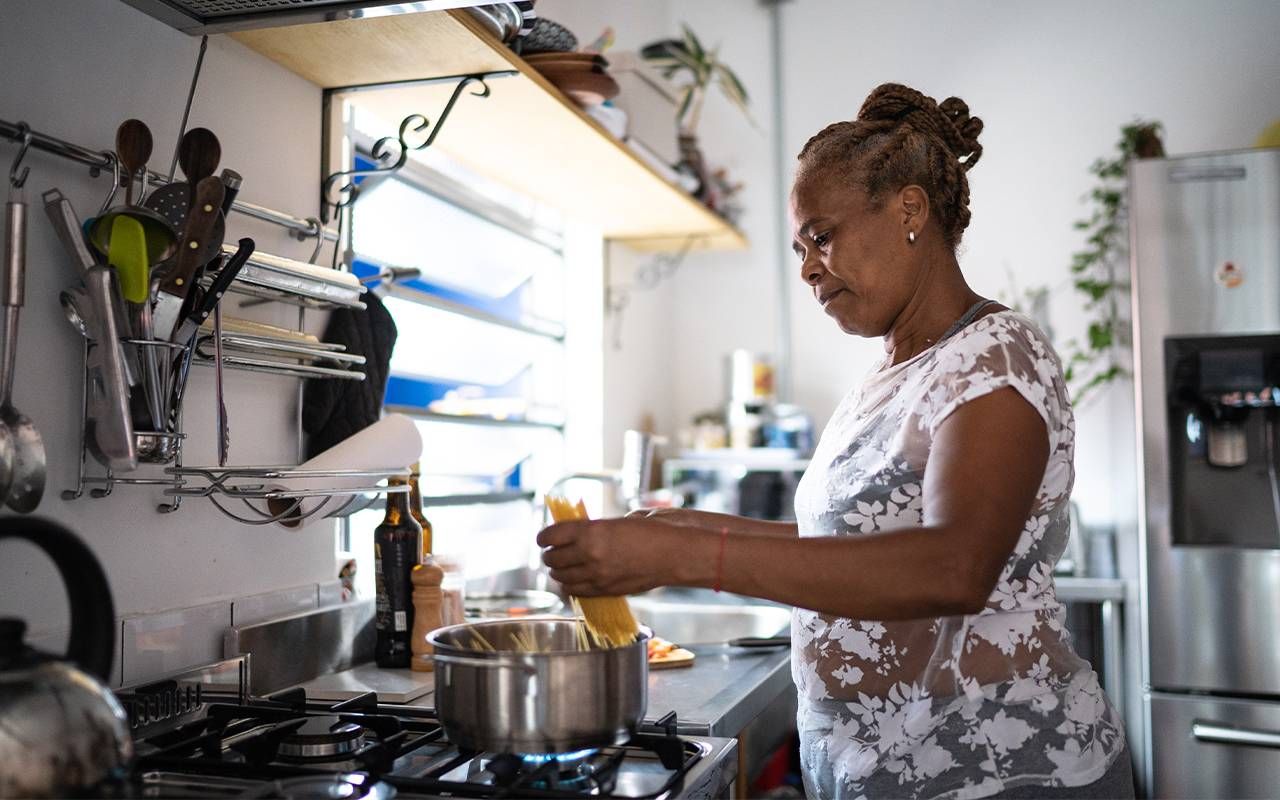An older adult cooking at home. Next Avenue, food security, brain health