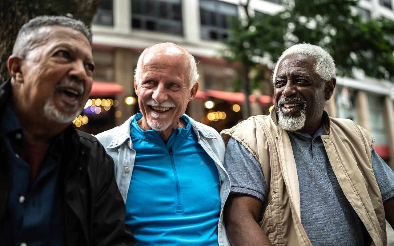 Three friends sitting together. Next Avenue, happiness study