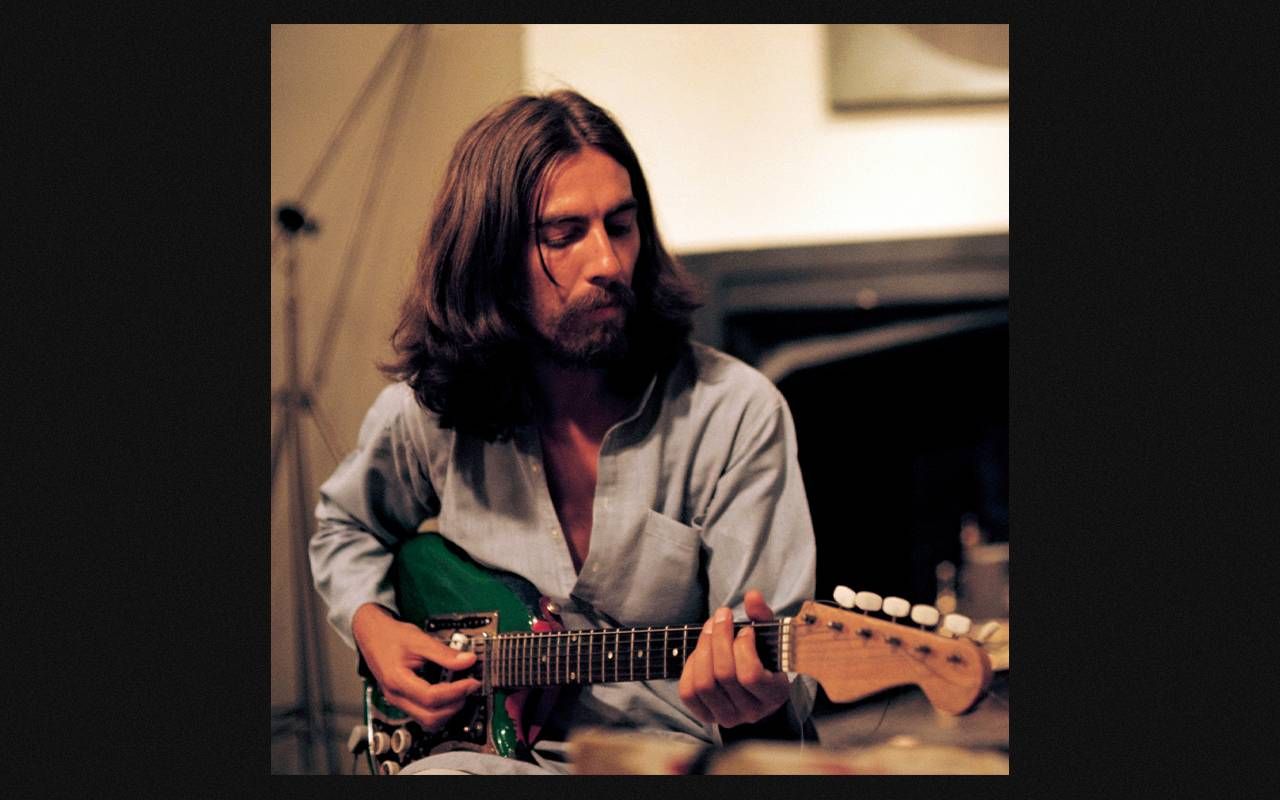 George Harrison playing a guitar. Next Avenue, the beatles, George Harrison