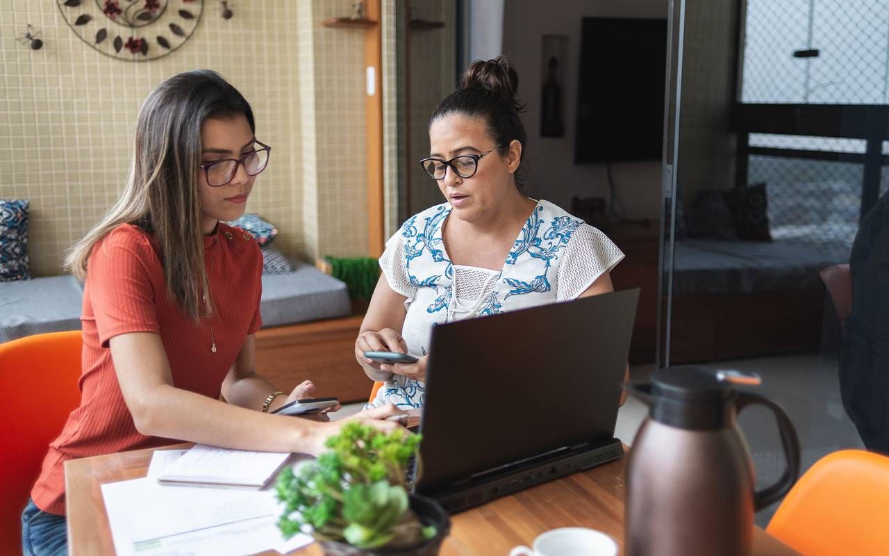 A mother helping her adult daughter with her finances. Next Avenue, financially supporting adult children