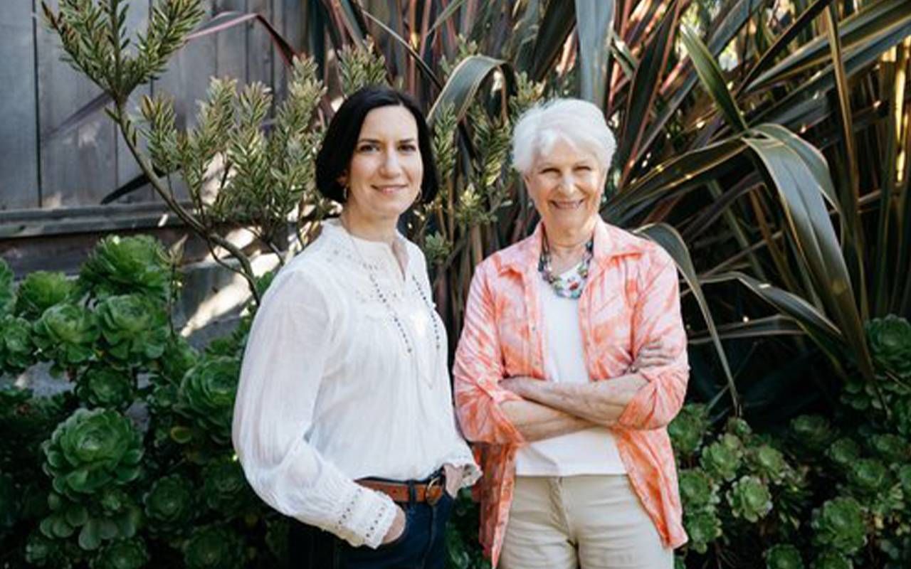 Two women standing outside smiling. Next Avenue, talking about retirement with partner