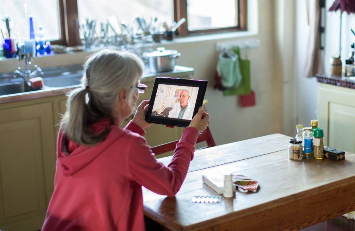 An older adult during a telehealth appointment at home. Next Avenue, virtual appointment, telemedicine