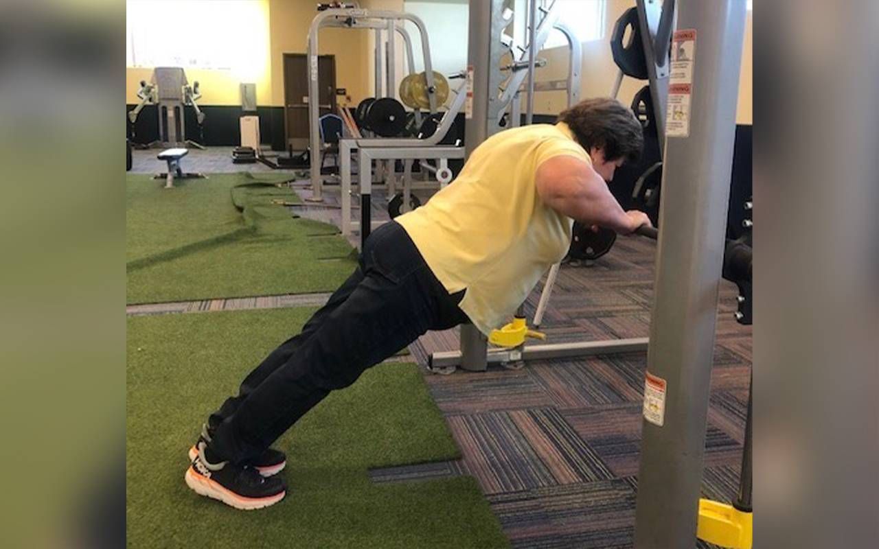 An older adult working out in a gym. Next Avenue, personal trainer for older adult