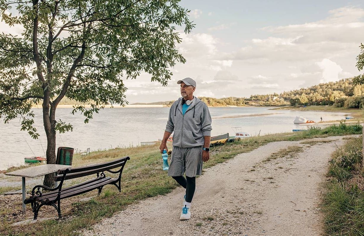 A 70-year-old man taking a walk around a lake. Next Avenue, turning 70