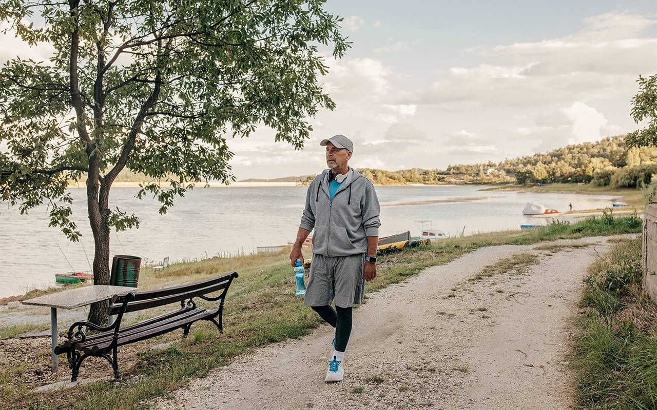 A 70-year-old man taking a walk around a lake. Next Avenue, turning 70