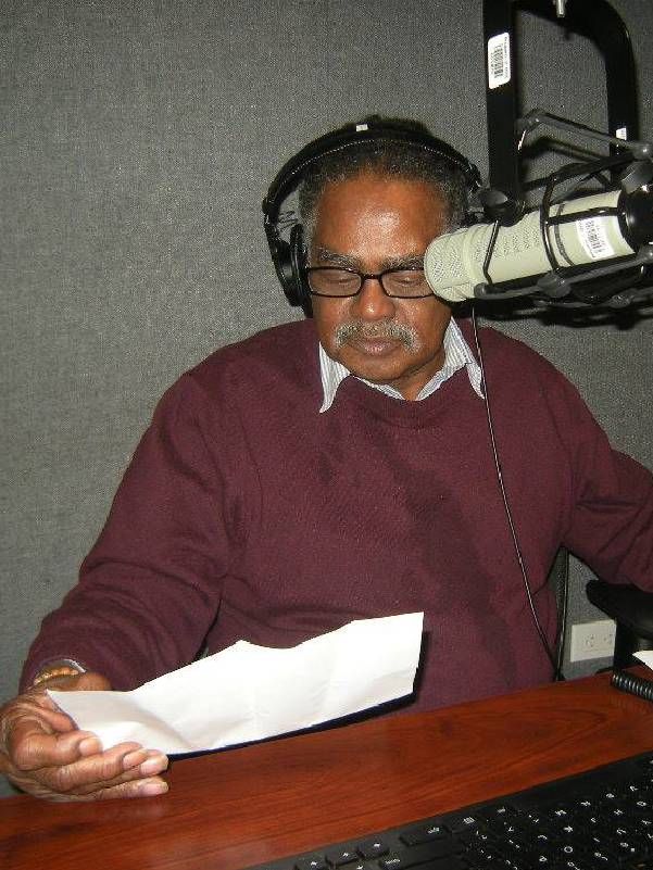 A man sitting in an audio booth. Next Avenue, arts organizations