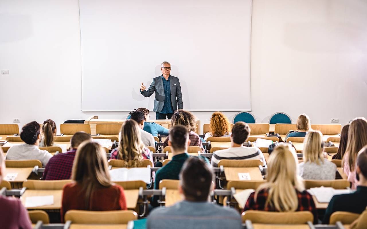 A college professor teaching in front of his class. Next Avenue, wading into retirement, gradual retirement