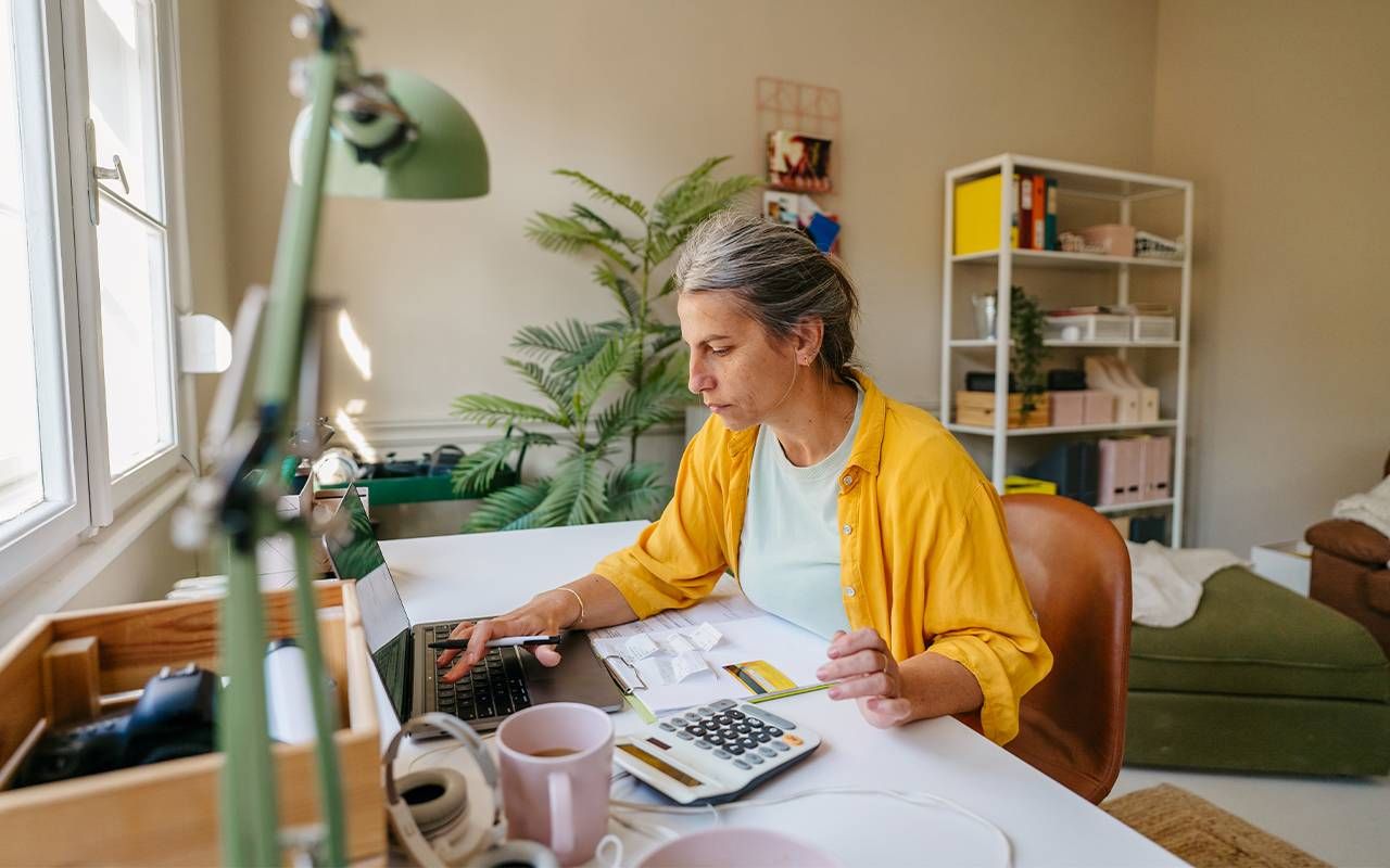 A woman working on her loved one's finances. Next Avenue, emergency financial file