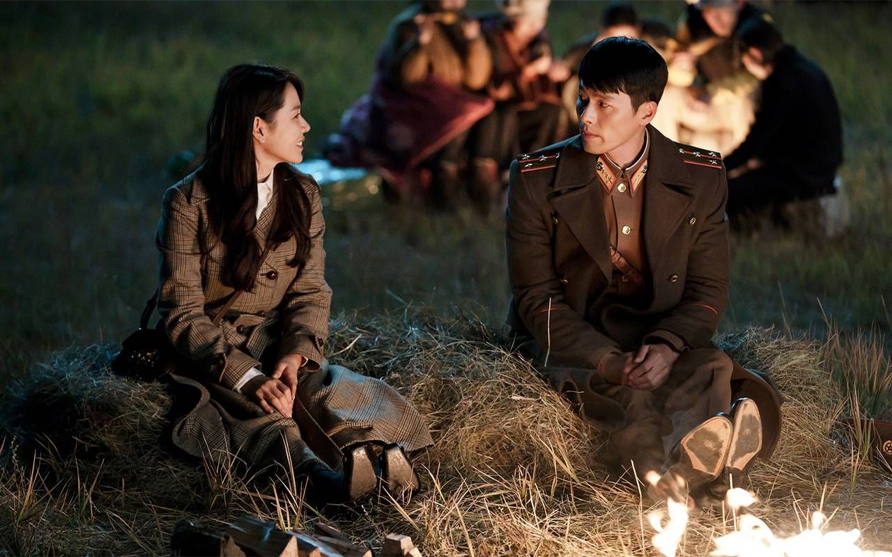 Two people sitting by a fire. Next Avenue, Korean Drama