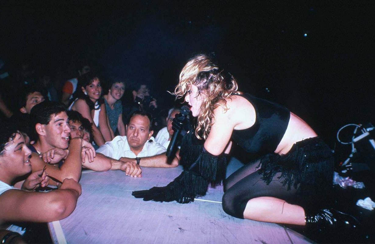 Madonna on stage during a concert. Next Avenue