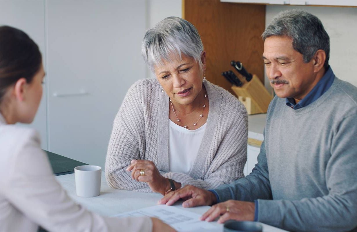 Two older adults speaking to a trusted advisor. Next Avenue