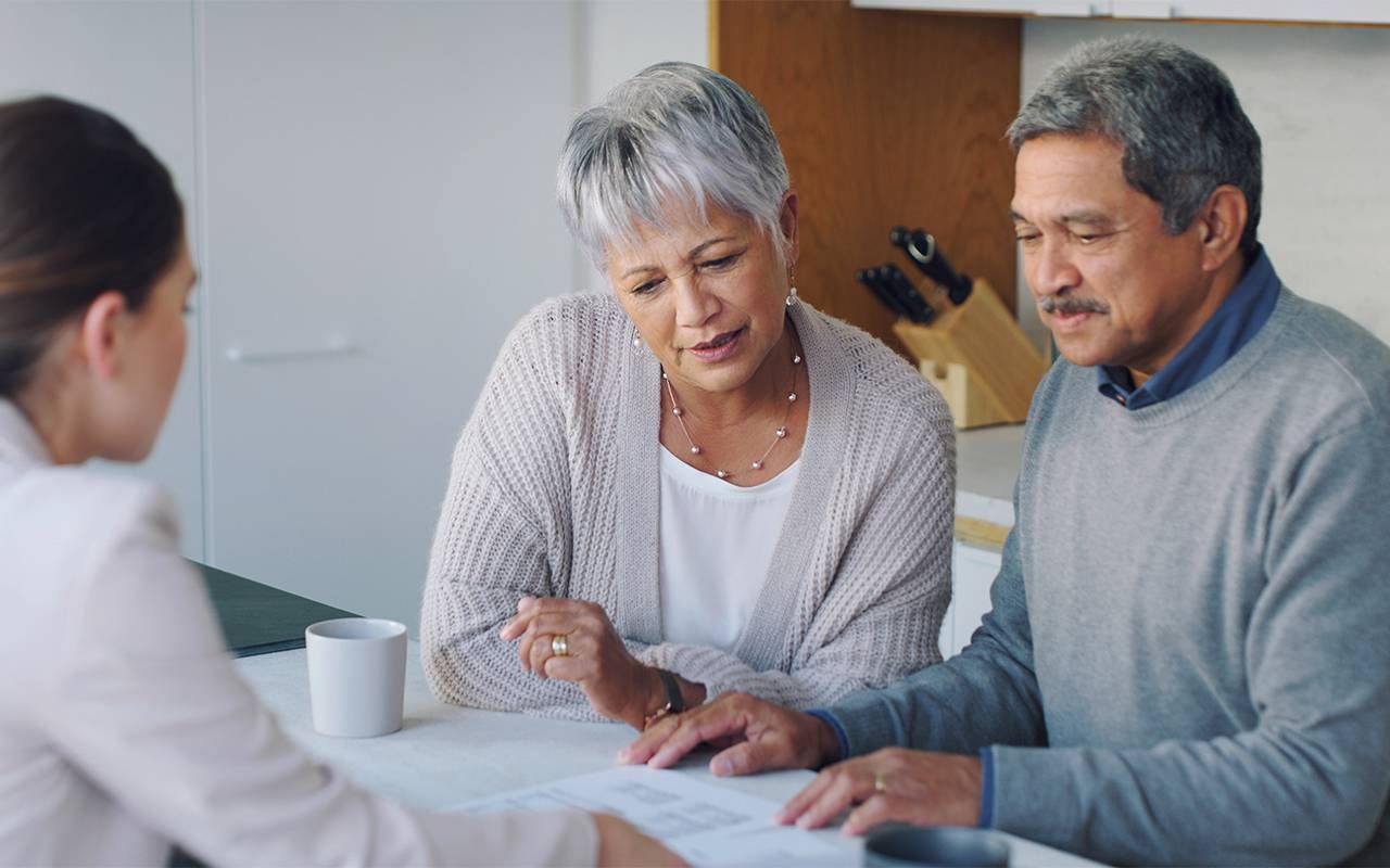 Two older adults speaking to a trusted advisor. Next Avenue