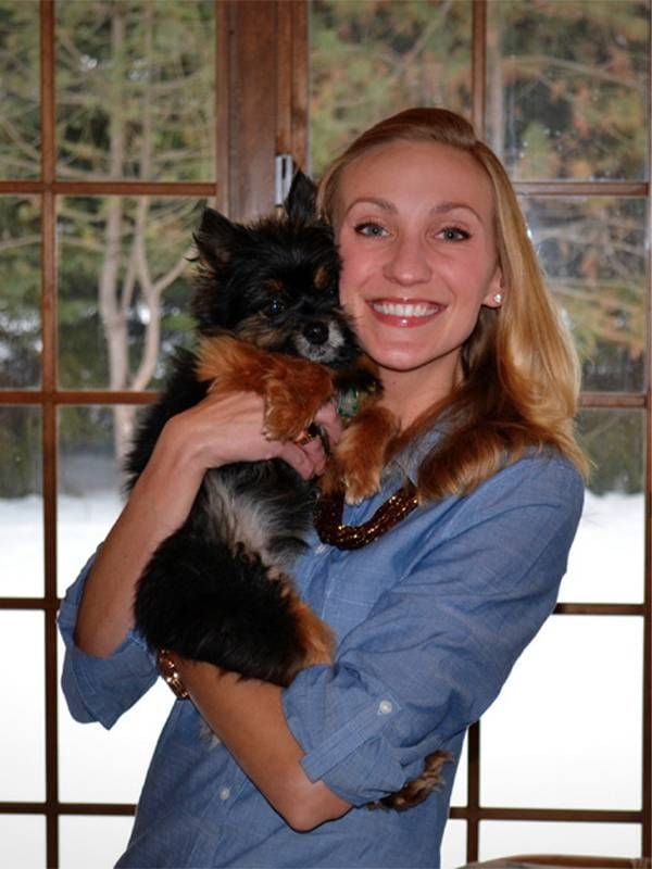 A woman holding a small dog. Next Avenue, in-home euthanasia for pet, putting pet down at home