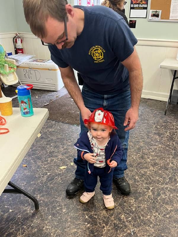 A man with a young child. Next Avenue, second act, new career, firefighter