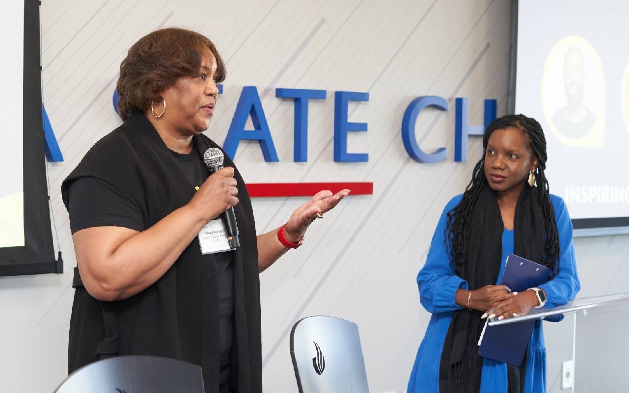 Two women speaking at an event. Next Avenue, small business, entrepreneurs