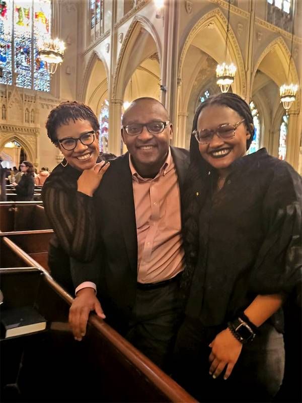 A family smiling inside a church. Next Avenue, turning 50, reflecting at 50