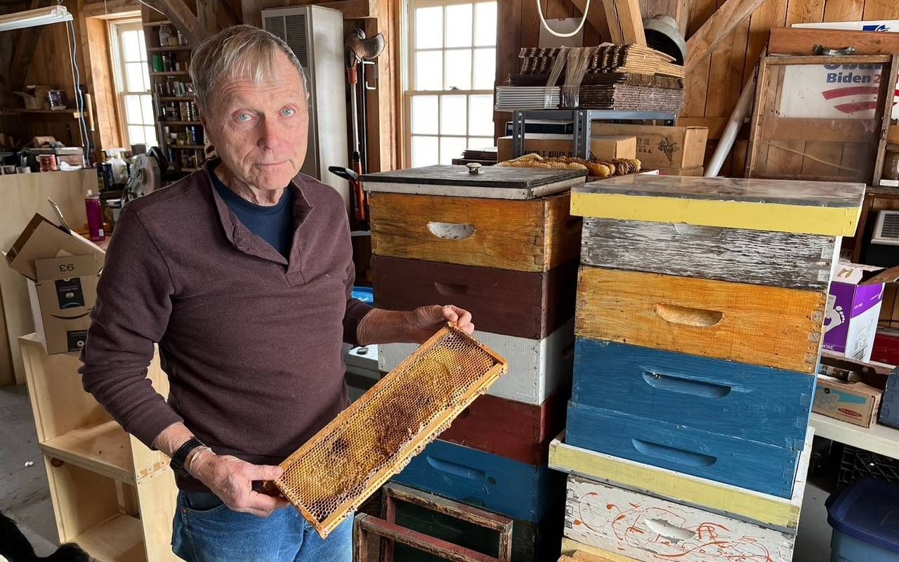 A man standing with a bee hive. Next Avenue, allergies, climate change