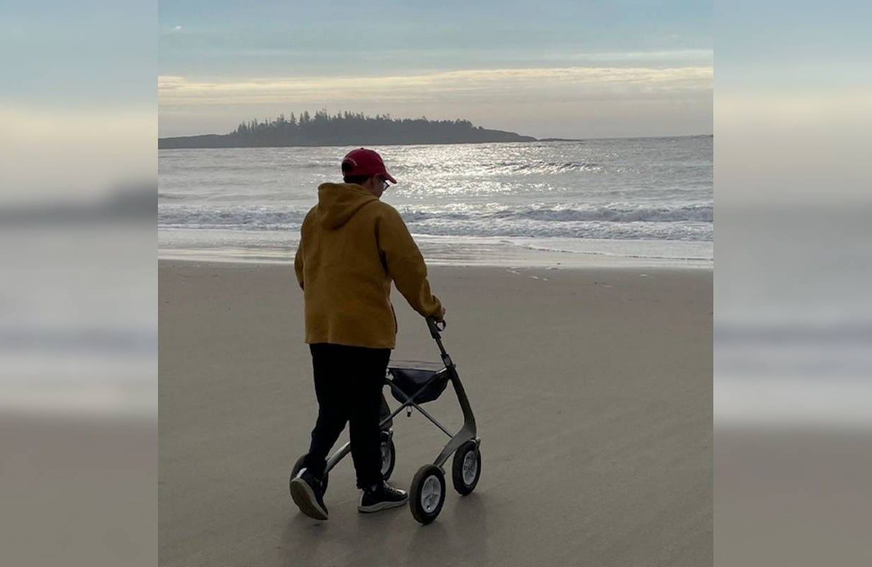 A person using a mobility aid on the beach. Next Avenue, assisted devices