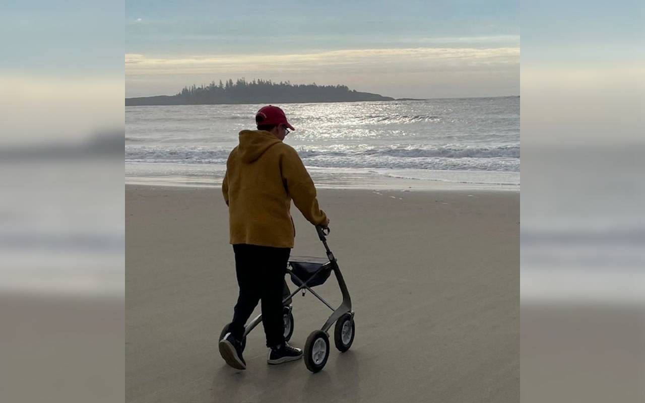 A person using a mobility aid on the beach. Next Avenue, assisted devices