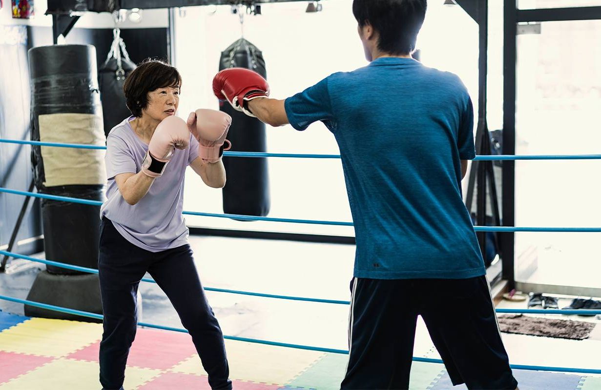 An older woman in the boxing gym. Next Avenue, Parkinson's disease, boxing