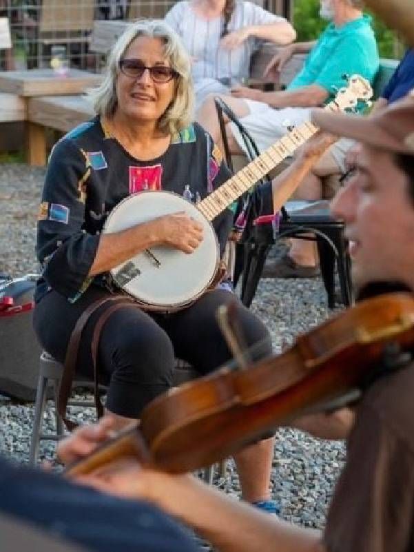 A woman playing the banjo. Next Avenue, North and South Carolina arts
