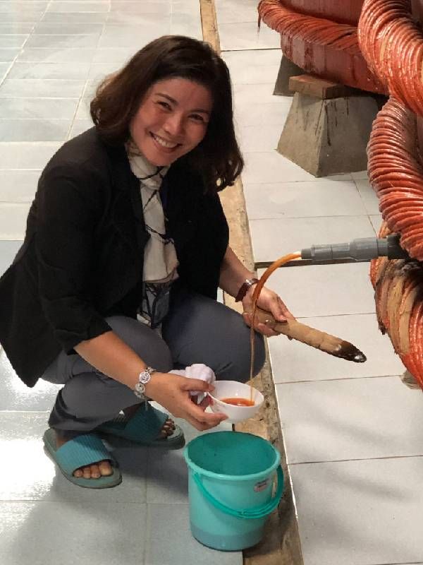 A woman kneeling near a spigot. Next Avenue