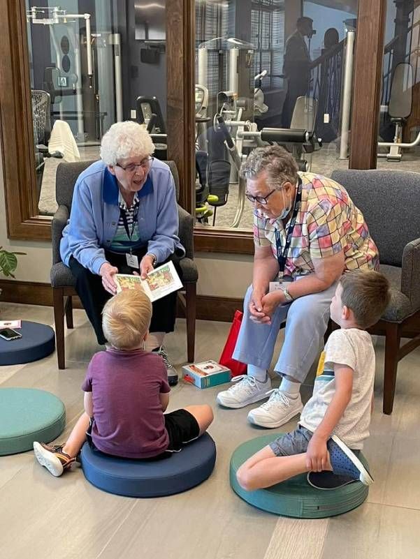 An older adult reading to children. Next Avenue, intergenerational