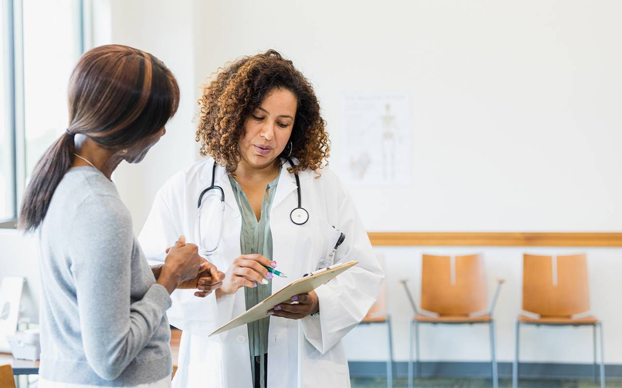 A woman talking to her doctor about strengthening her pelvic floor. Next Avenue