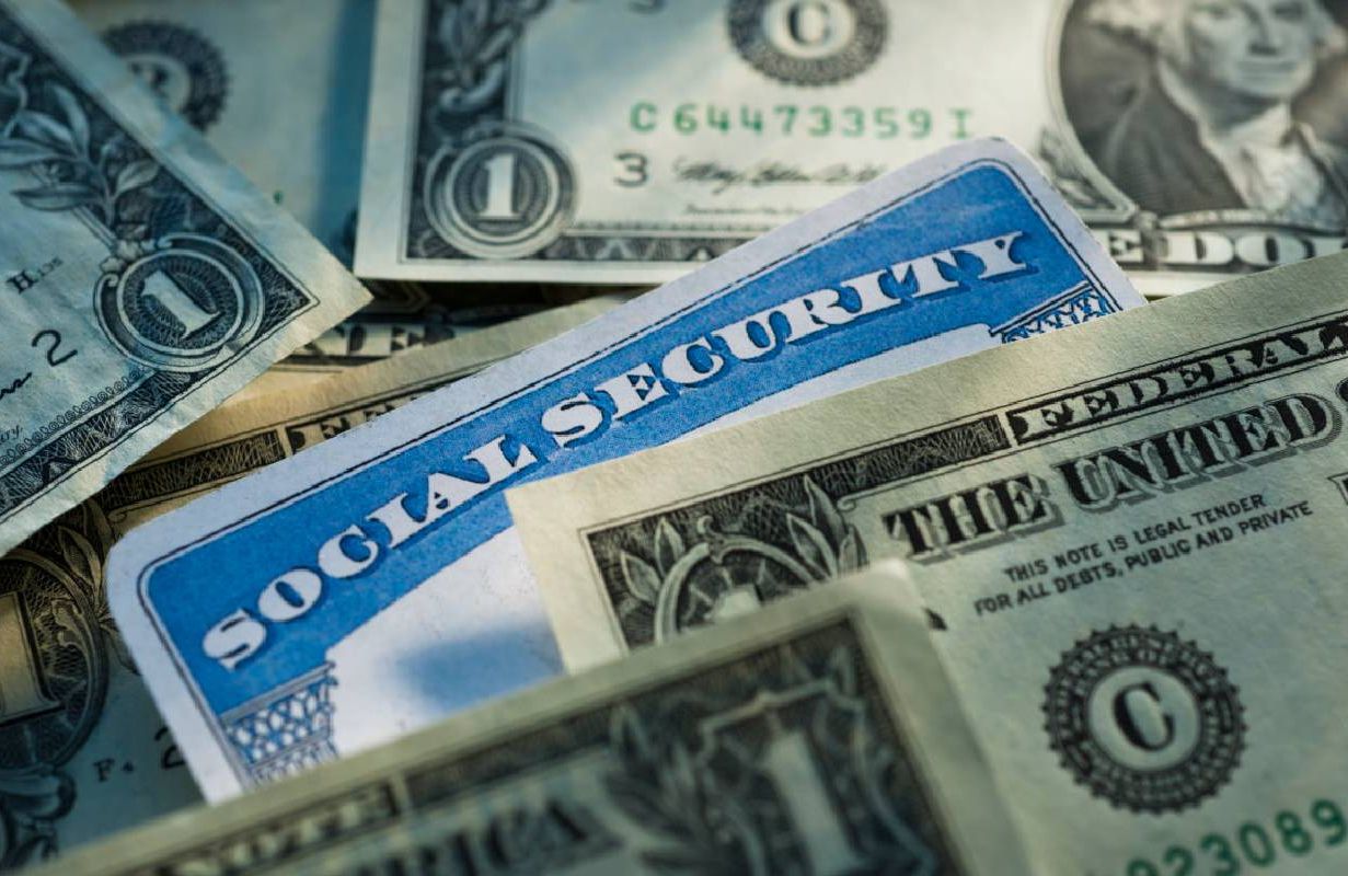 U.S. dollar bills and a social security card. Next Avenue, social security retirement benefits